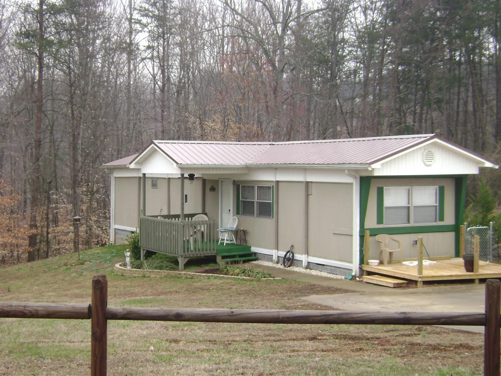 Mauve metal roof on a manufactured home with a new front deck in Worden